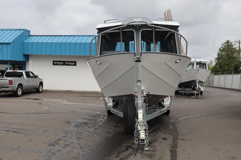 Slide: The Image of 2026 KingFisher 2825 Coastal Express boat on trailer, parked outside dealership. - 4