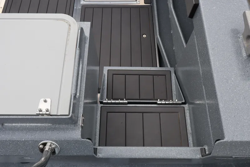 Slide: The Image of 2026 KingFisher 2825 Coastal Express boat deck with storage compartments. - 5