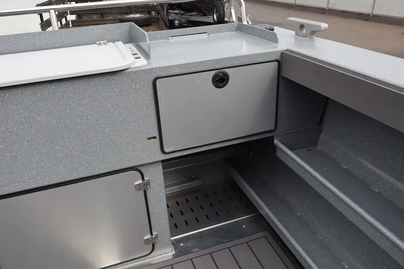 Slide: The Image of Interior view of 2026 KingFisher 2825 Coastal Express boat, featuring storage compartments. - 7