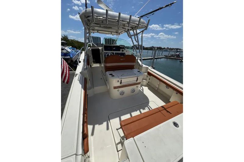 Slide: The Image of 2006 Hydra-Sports Vector 3300 VX boat interior with seating and helm, docked by the water. - 11