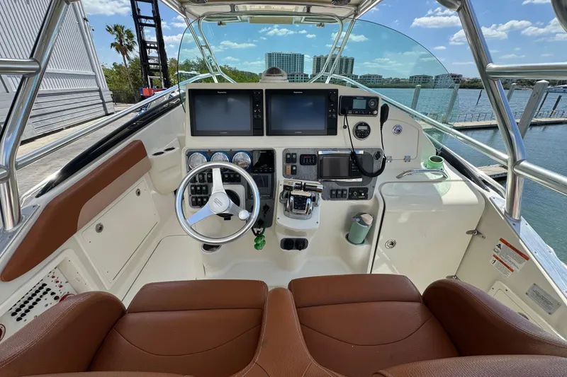 Slide: The Image of 2006 Hydra-Sports Vector 3300 VX boat cockpit with modern navigation equipment and leather seating. - 13