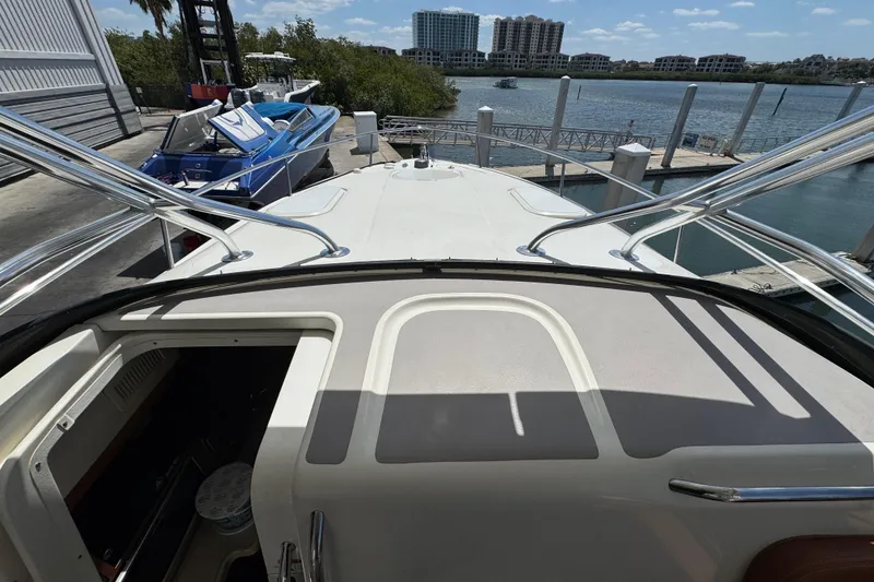 Slide: The Image of 2006 Hydra-Sports Vector 3300 VX boat docked, with view of marina and surrounding buildings. - 21