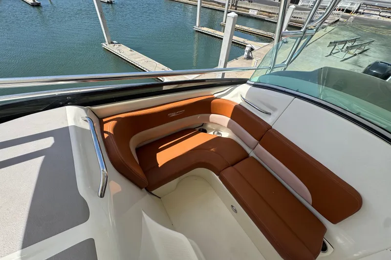 Slide: The Image of 2006 Hydra-Sports Vector 3300 VX boat interior with brown seating, docked at marina. - 23