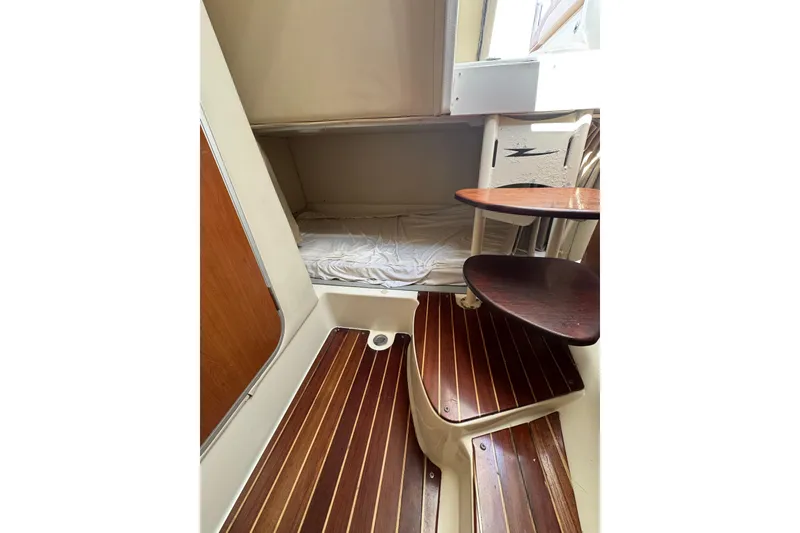 Slide: The Image of 2006 Hydra-Sports Vector 3300 VX cabin interior with wooden steps and cozy sleeping area. - 25