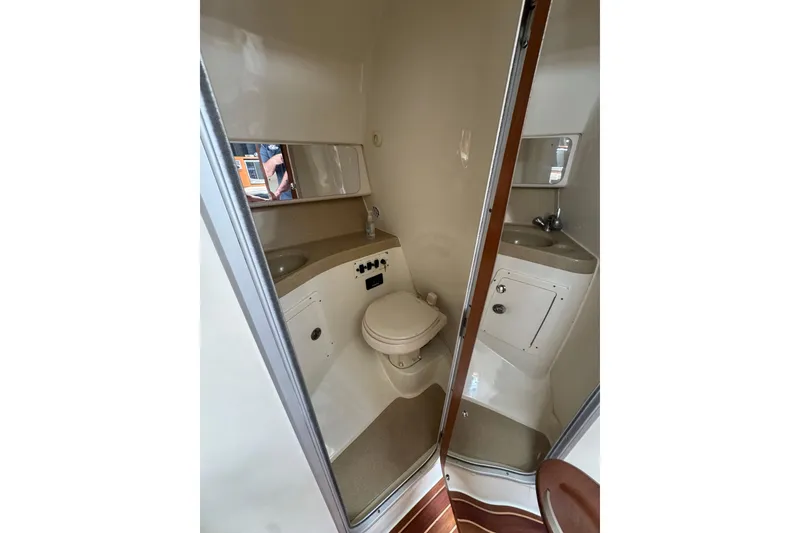 Slide: The Image of 2006 Hydra-Sports Vector 3300 VX boat bathroom with sink, toilet, and mirror. - 26