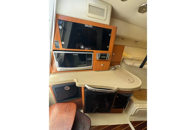 Slide: The Image of 2006 Hydra-Sports Vector 3300 VX cabin interior with kitchenette and appliances. - 27