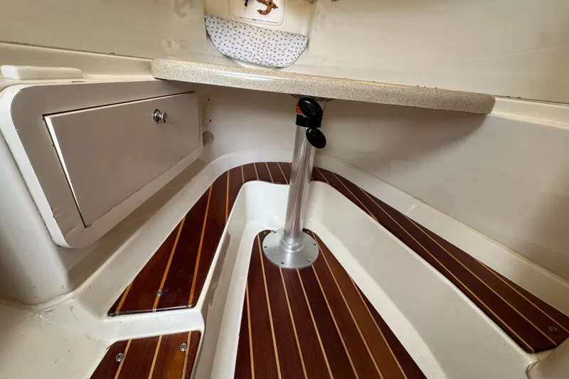 Slide: The Image of 2006 Hydra-Sports Vector 3300 VX cabin interior with wood flooring and storage compartment. - 28