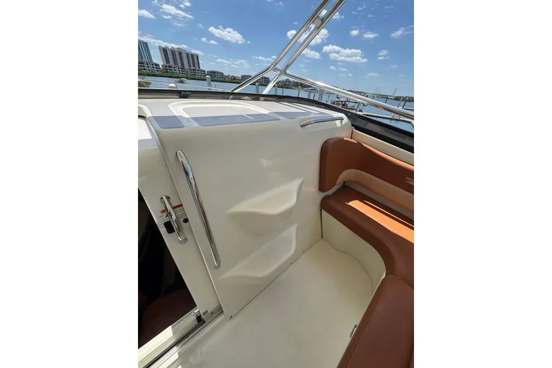 Slide: The Image of 2006 Hydra-Sports Vector 3300 VX interior with brown seating and chrome accents. - 31