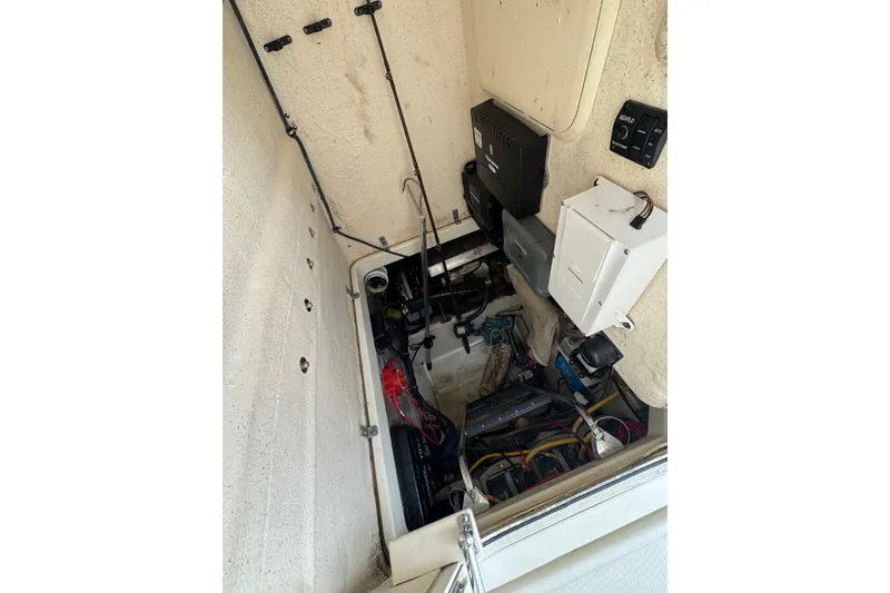Slide: The Image of Engine compartment of a 2006 Hydra-Sports Vector 3300 VX boat, showcasing wiring and components. - 32