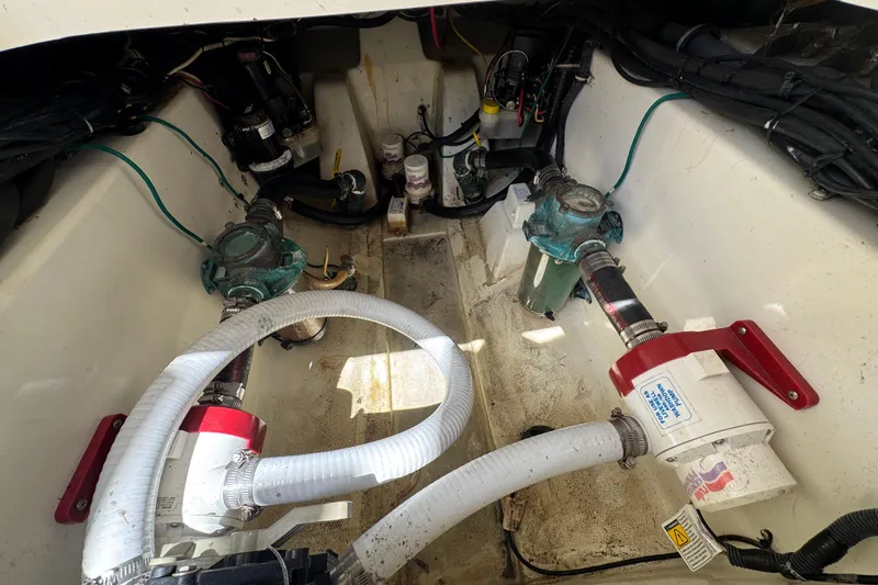 Slide: The Image of Engine compartment of a 2006 Hydra-Sports Vector 3300 VX boat, showing pumps and hoses. - 33