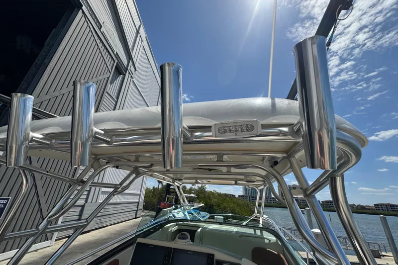 Slide: The Image of 2006 Hydra-Sports Vector 3300 VX boat with stainless steel rod holders and T-top under sunny sky. - 36