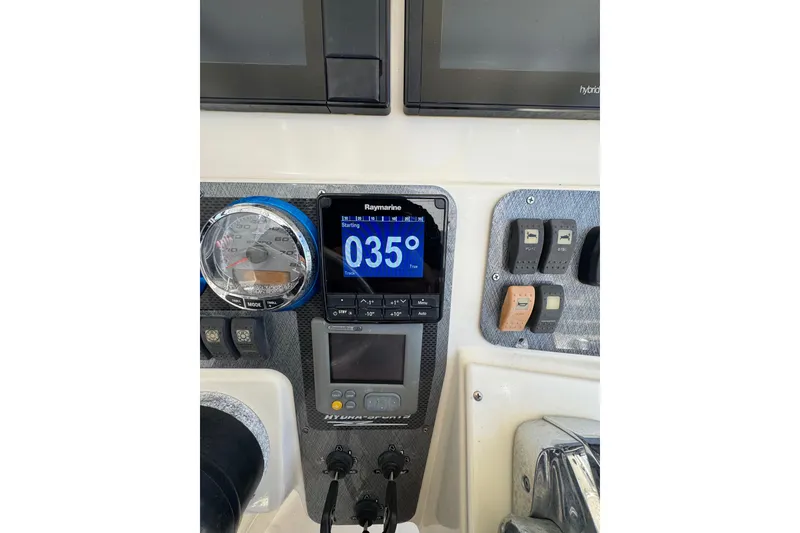 Slide: The Image of Control panel of a 2006 Hydra-Sports Vector 3300 VX boat with navigation instruments. - 38