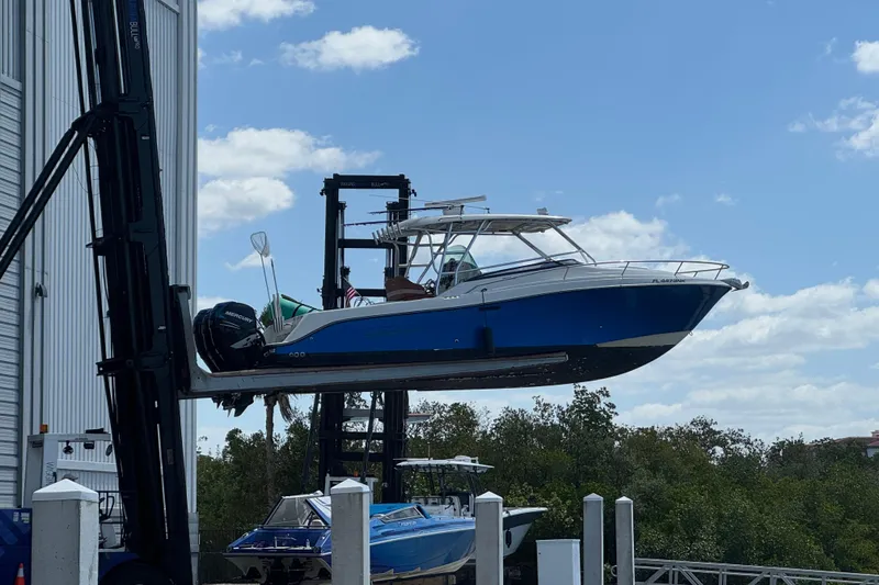 Slide: The Image of 2006 Hydra-Sports Vector 3300 VX boat lifted by forklift against blue sky. - 4