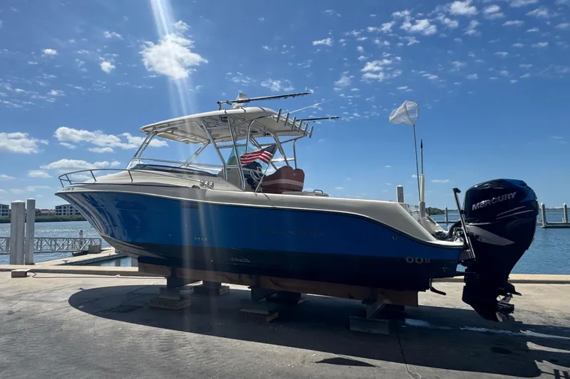 Slide: The Image of 2006 Hydra-Sports Vector 3300 VX boat on dock, blue hull, Mercury outboard engine. - 5