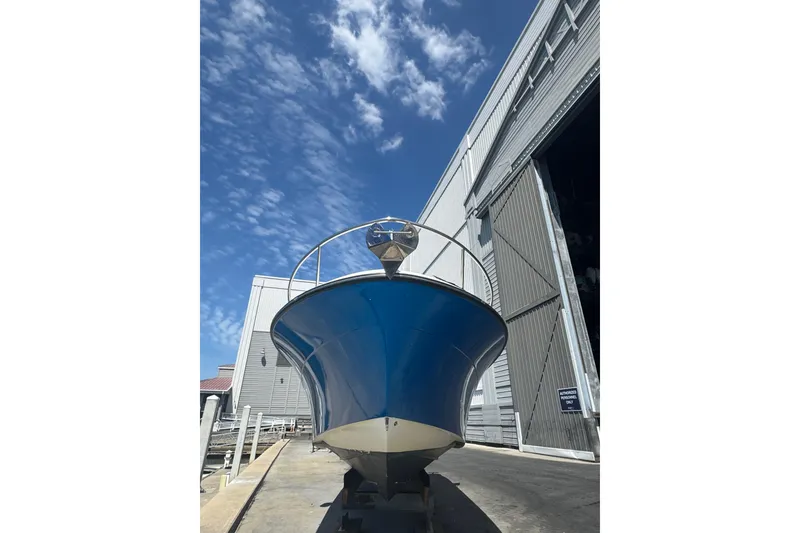 Slide: The Image of 2006 Hydra-Sports Vector 3300 VX boat outside a large warehouse under a blue sky. - 6
