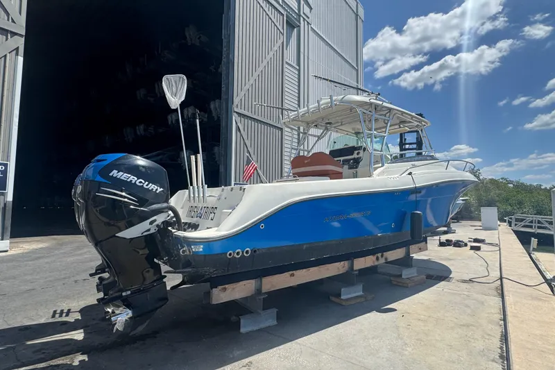 Slide: The Image of 2006 Hydra-Sports Vector 3300 VX boat with Mercury engine, docked under sunny skies. - 7