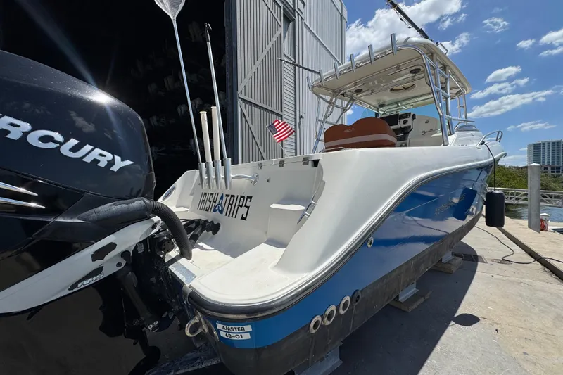 Slide: The Image of 2006 Hydra-Sports Vector 3300 VX boat docked, featuring Mercury engine and fishing equipment. - 8