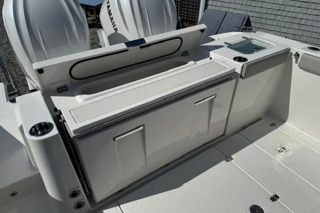 Slide: The Image of 2026 Pursuit S 328 Sport boat deck with storage compartments and Yamaha engines. - 10