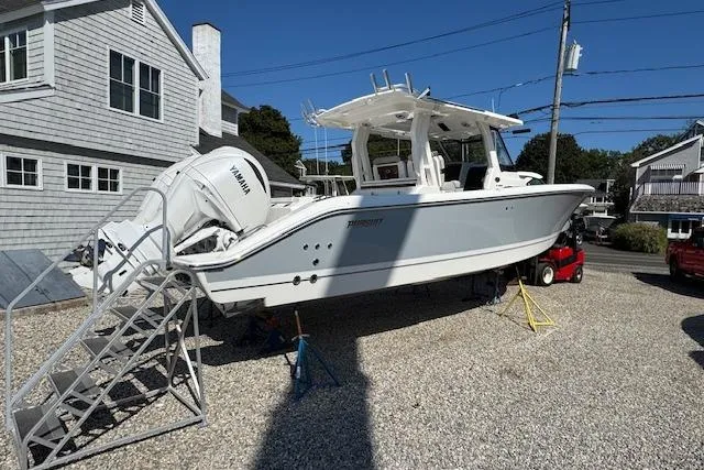 Slide: The Image of 2026 Pursuit S 328 Sport boat on display with Yamaha engines, parked on gravel. - 2