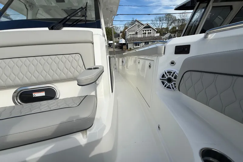 Slide: The Image of 2026 Pursuit S 328 Sport boat interior with cushioned seating and speaker system. - 29