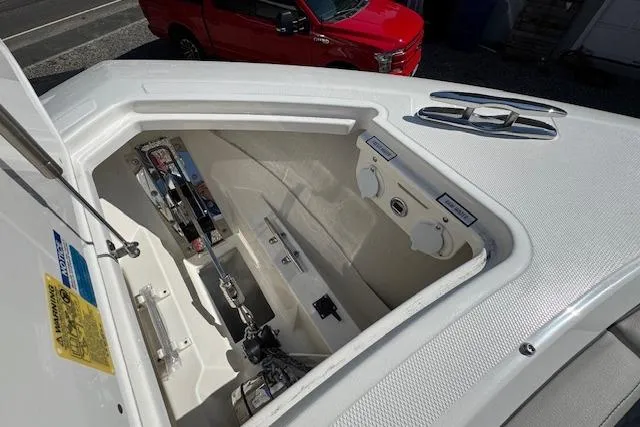 Slide: The Image of 2026 Pursuit S 328 Sport boat storage compartment with open hatch, showcasing interior details. - 31
