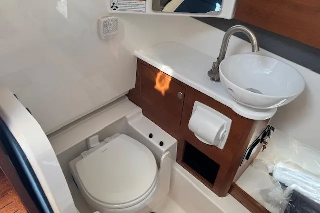Slide: The Image of 2026 Pursuit S 328 Sport boat bathroom with modern sink and toilet. - 33