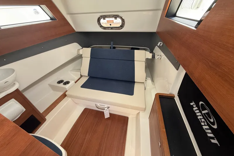 Slide: The Image of Interior of 2026 Pursuit S 328 Sport boat with seating and wood accents. - 35