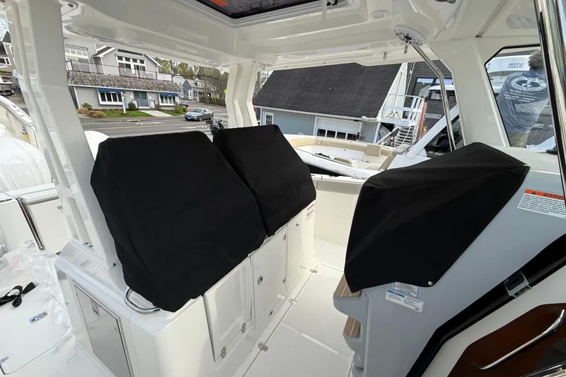 Slide: The Image of 2026 Pursuit S 328 Sport boat interior with covered seating and modern design. - 40