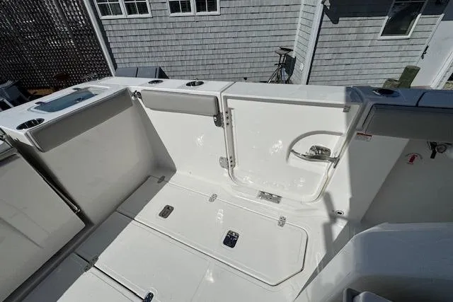 Slide: The Image of 2026 Pursuit S 328 Sport boat deck with storage compartments and clean white finish. - 5