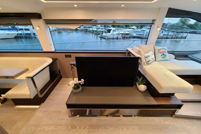 Slide: The Image of Luxurious interior of 2023 Sunseeker Manhattan 68 yacht with elegant seating and waterfront view. - 13