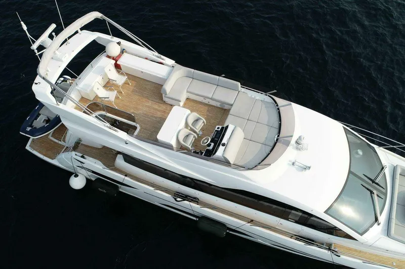Slide: The Image of 2023 Sunseeker Manhattan 68 yacht, aerial view, luxurious deck and seating area. - 2