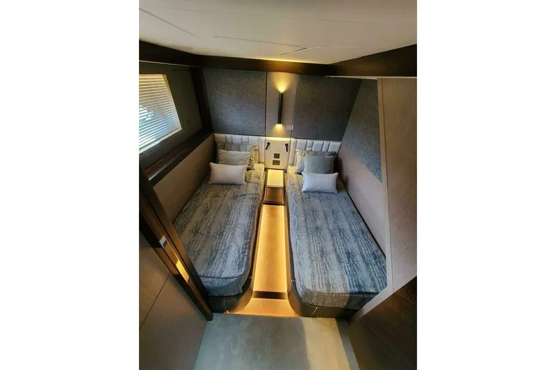 Slide: The Image of Luxurious twin cabin interior of 2023 Sunseeker Manhattan 68 yacht, featuring modern design and ambient lighting. - 29