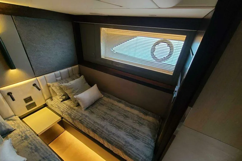 Slide: The Image of Luxurious cabin interior of 2023 Sunseeker Manhattan 68 yacht with modern bedding and window. - 30