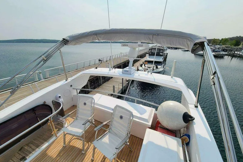 Slide: The Image of 2023 Sunseeker Manhattan 68 yacht deck with chairs, docked at marina. - 42