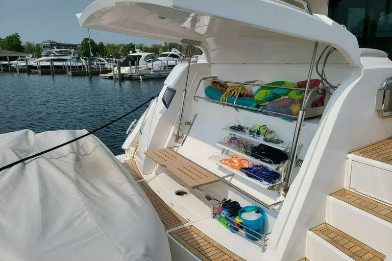 Slide: The Image of 2023 Sunseeker Manhattan 68 yacht with open storage, docked at marina. - 46