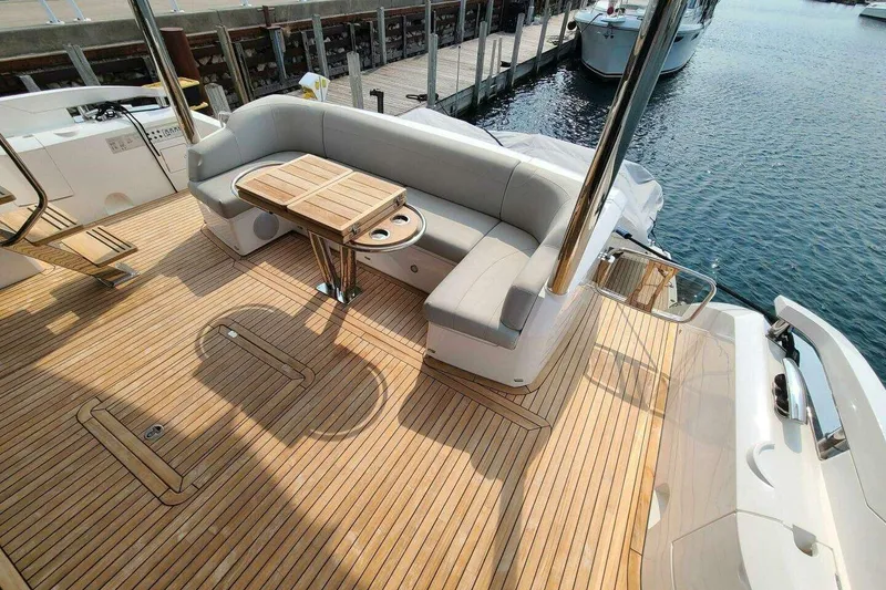 Slide: The Image of Luxurious Sunseeker Manhattan 68 yacht deck with elegant seating and wooden flooring, 2023 model. - 6