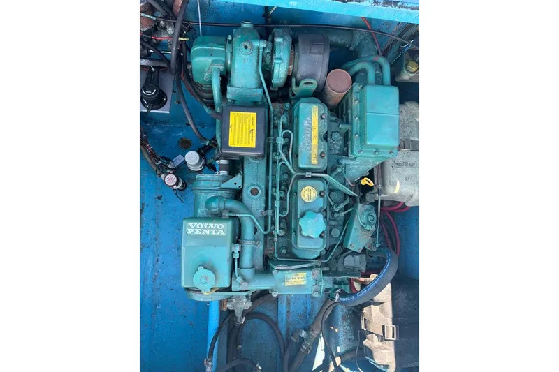 Slide: The Image of Volvo Penta engine in a 1976 Wilson 24 boat, featuring blue components and wiring. - 8