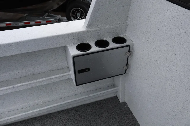 Slide: The Image of Interior detail of 2026 KingFisher 2825 Coastal Express boat with cup holders and storage compartment. - 12