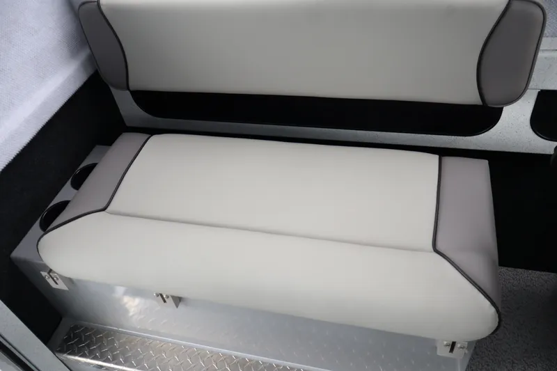 Slide: The Image of 2026 KingFisher 2825 Coastal Express interior seating with cup holders and diamond plate flooring. - 16