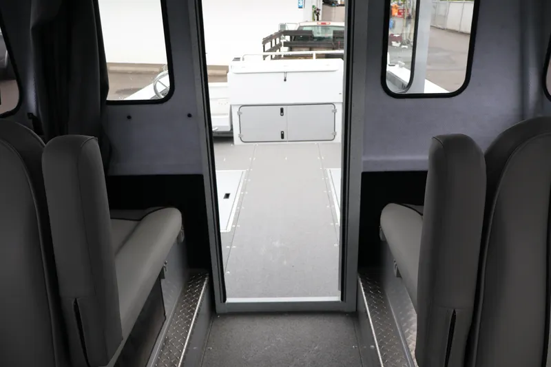 Slide: The Image of Interior view of 2026 KingFisher 2825 Coastal Express boat, featuring seating and cabin layout. - 20