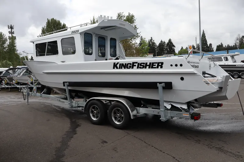Slide: The Image of 2026 KingFisher 2825 Coastal Express boat on trailer, parked outdoors. - 4
