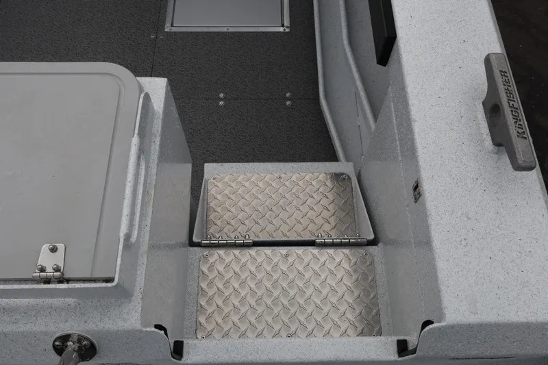 Slide: The Image of Interior view of 2026 KingFisher 2825 Coastal Express boat, featuring metal steps and textured flooring. - 6