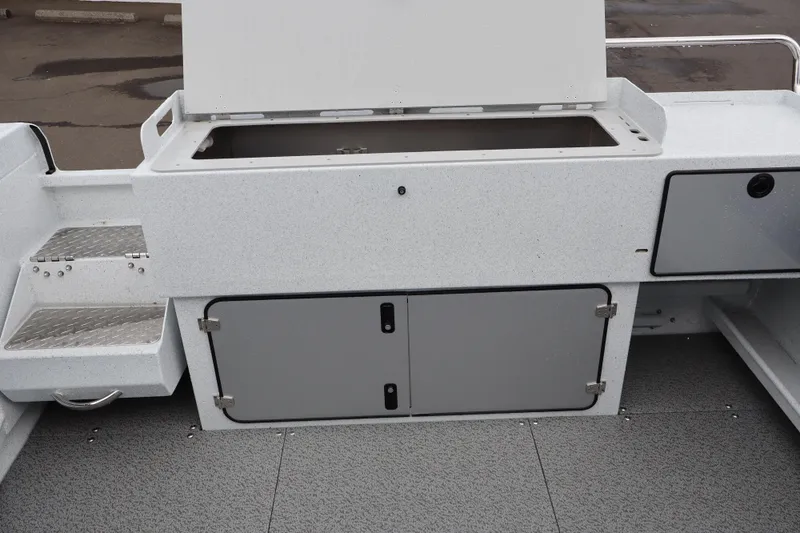 Slide: The Image of 2026 KingFisher 2825 Coastal Express boat interior with storage compartments and non-slip flooring. - 8