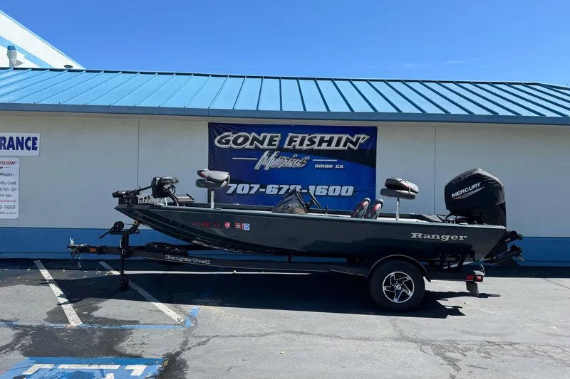 The Image of 2024 Ranger RT178 fishing boat on trailer outside dealership. - 1