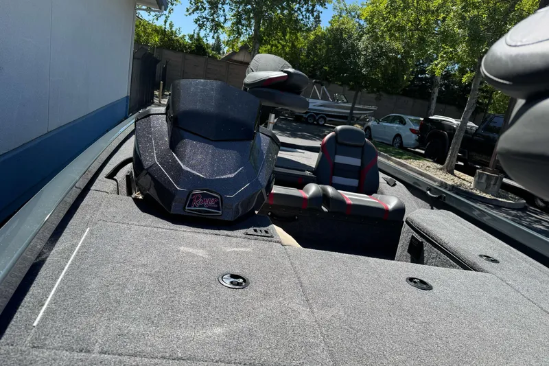 Slide: The Image of 2024 Ranger RT178 boat interior with seating and control panel, parked outdoors. - 11