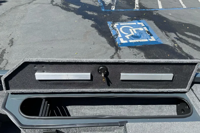 Slide: The Image of 2024 Ranger RT178 boat storage compartment with lock, parked near a handicap space. - 19