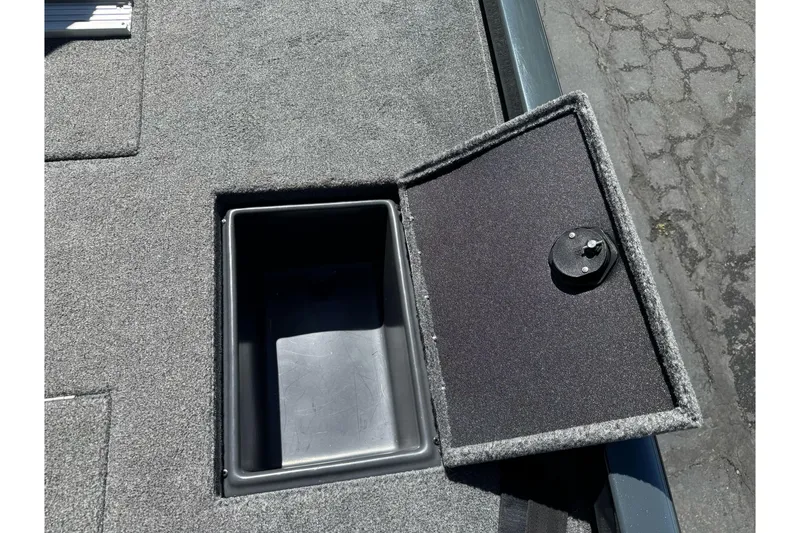Slide: The Image of 2024 Ranger RT178 boat storage compartment with open lid on carpeted deck. - 25