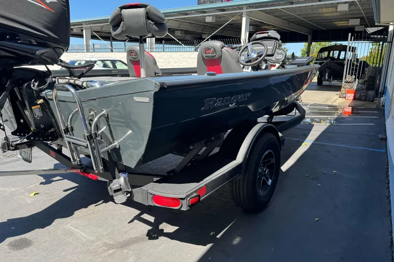 Slide: The Image of 2024 Ranger RT178 boat on trailer, parked outdoors, showcasing sleek design and modern features. - 6