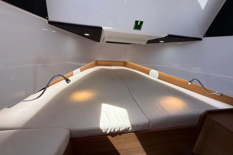 Slide: The Image of Interior cabin of 2026 VIRTUE YACHTS V10 TOP with cozy bedding and modern lighting. - 15