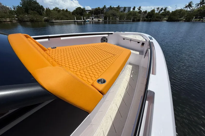 Slide: The Image of Luxury VIRTUE YACHTS V10 TOP 2026 with orange sunbed on deck, docked by serene waters. - 17